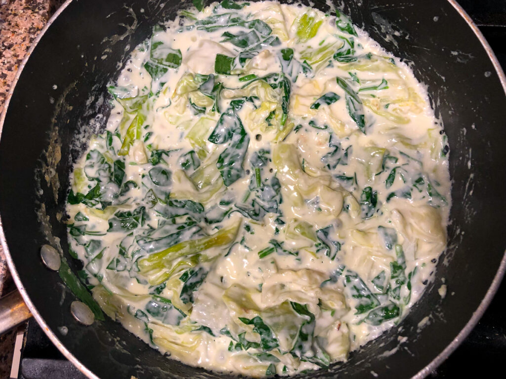 pan with cabbage and spinach in a cream sauce