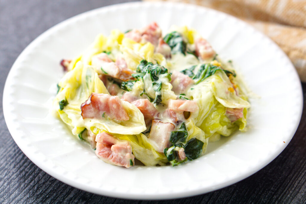 closeup of a plate of ham and cabbage in a cream sauce