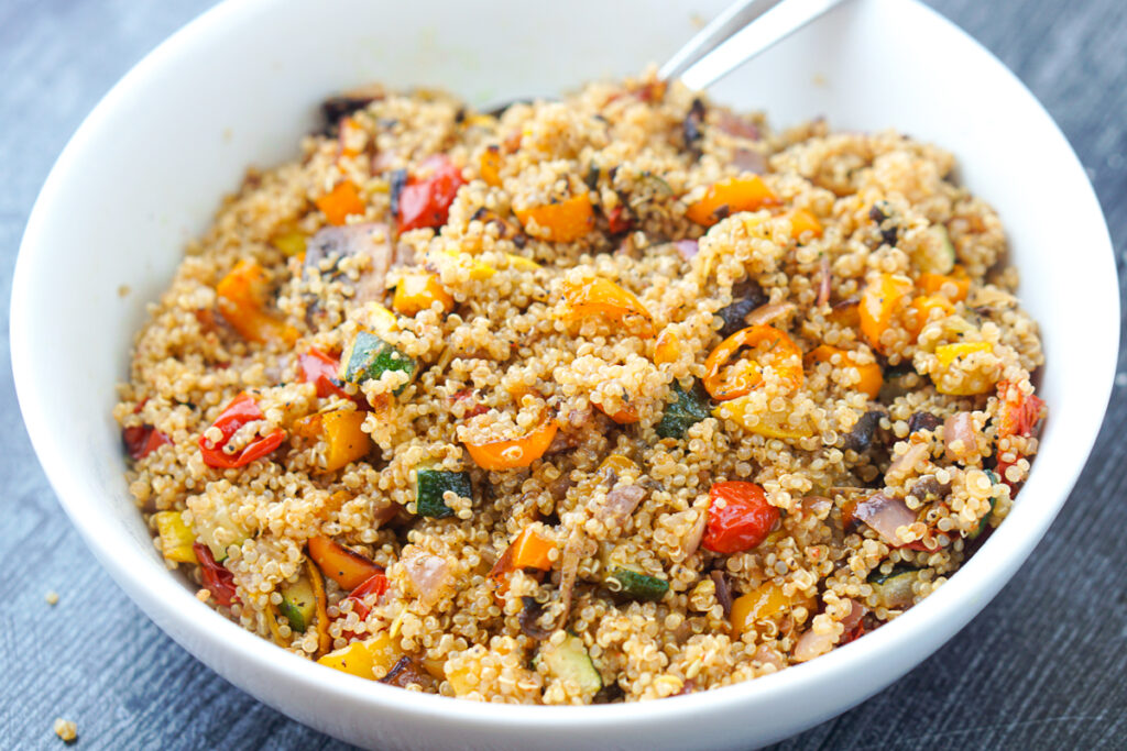 white bowl with the finished warm quinoa salad