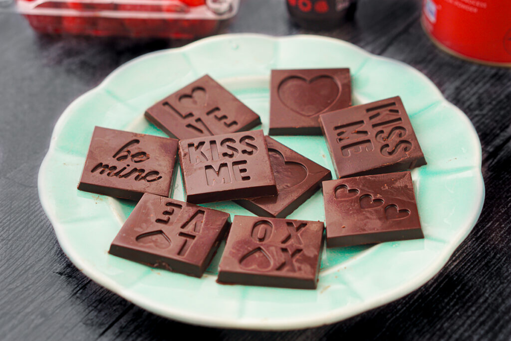 aqua plate with keto chocolate candies with Valentine's Day sayings
