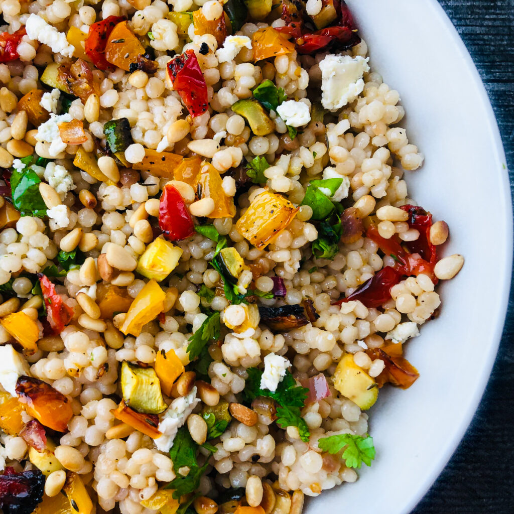 white bowl with closeup of roasted vegetable couscous salad