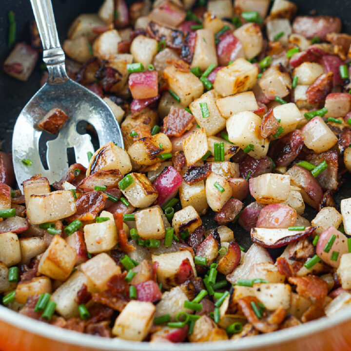 closeup of a pan of fried radishes and turnips with bacon
