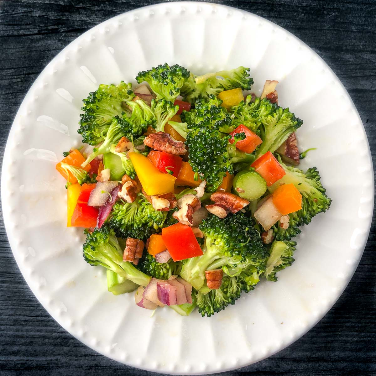white plate with keto broccoli salad