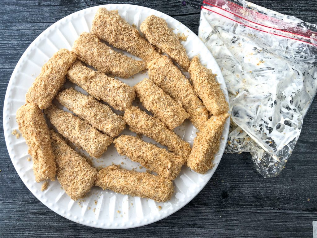 white plate with breaded fish pieces