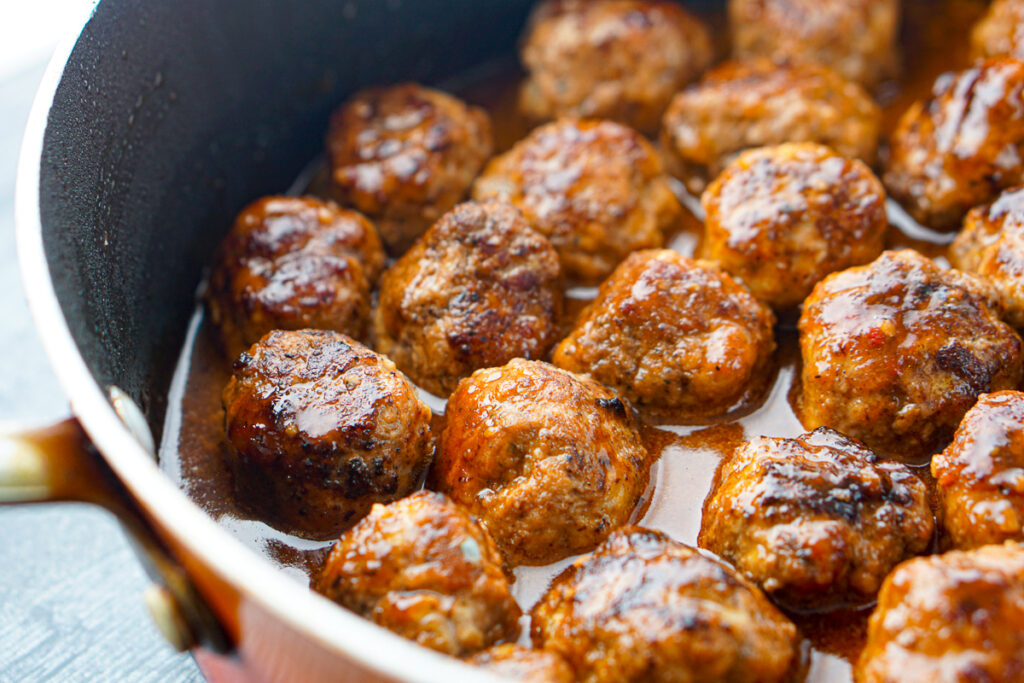 closeup of a pan of keto meatballs in bbq sauce