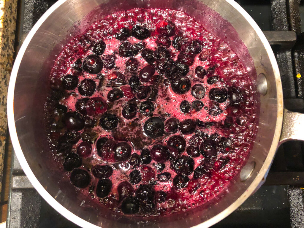 pan with a sugar free blueberry sauce cooking on the stove