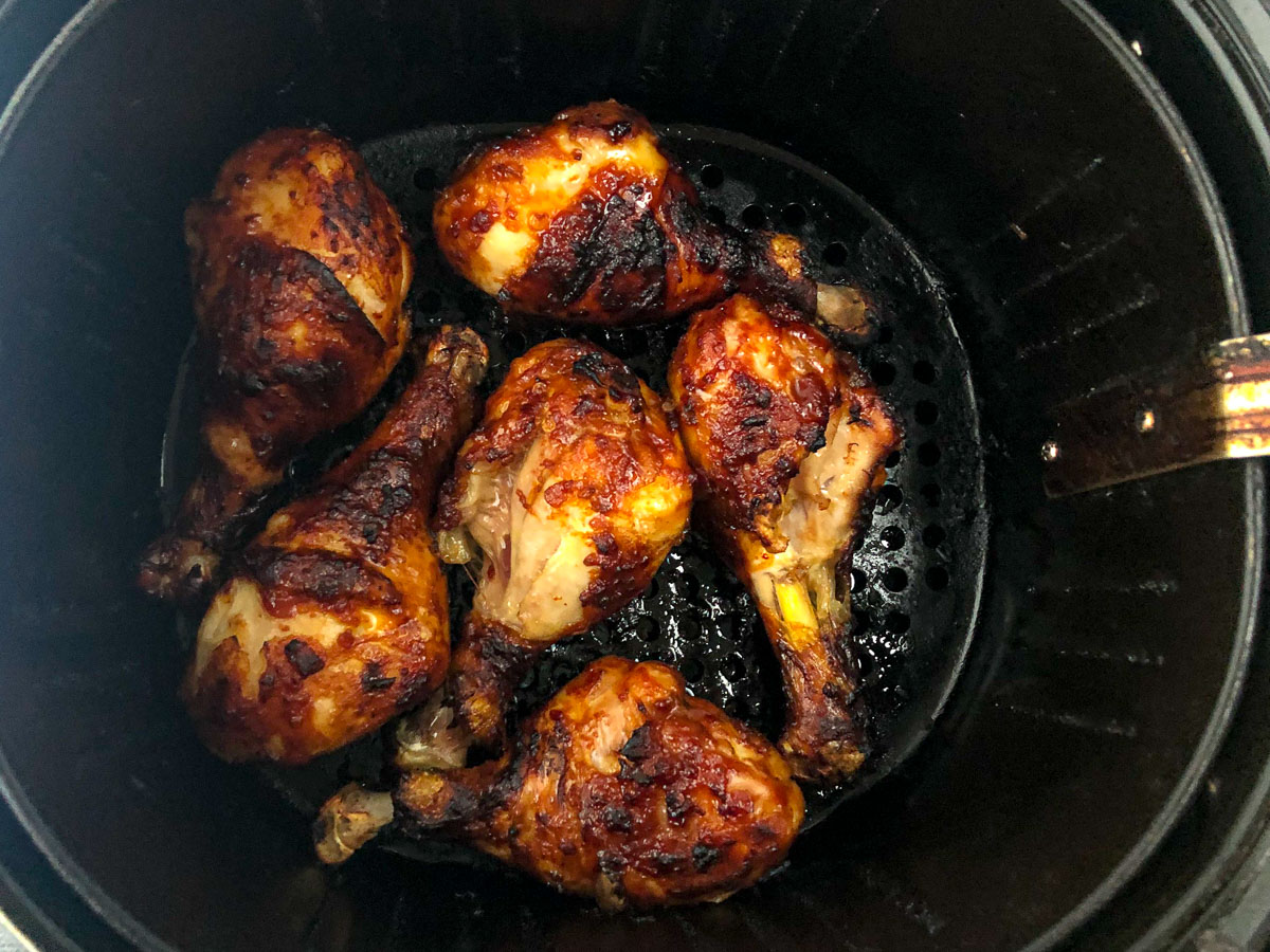 cooked sticky chicken in an air fryer basket