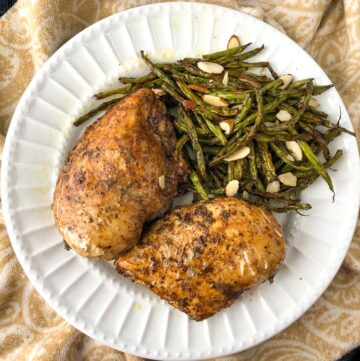 white plate with keto balsamic chicken and green beans made in the air fryer