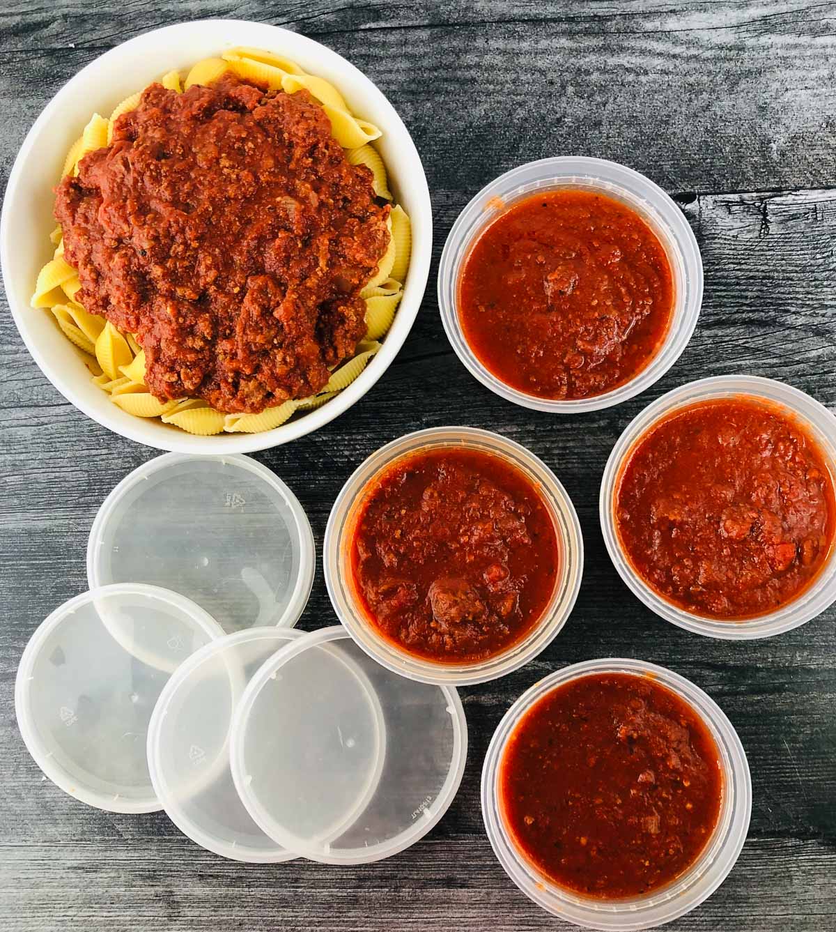 bowl of pasta and storage containers with slow cooker spaghetti meat sauce