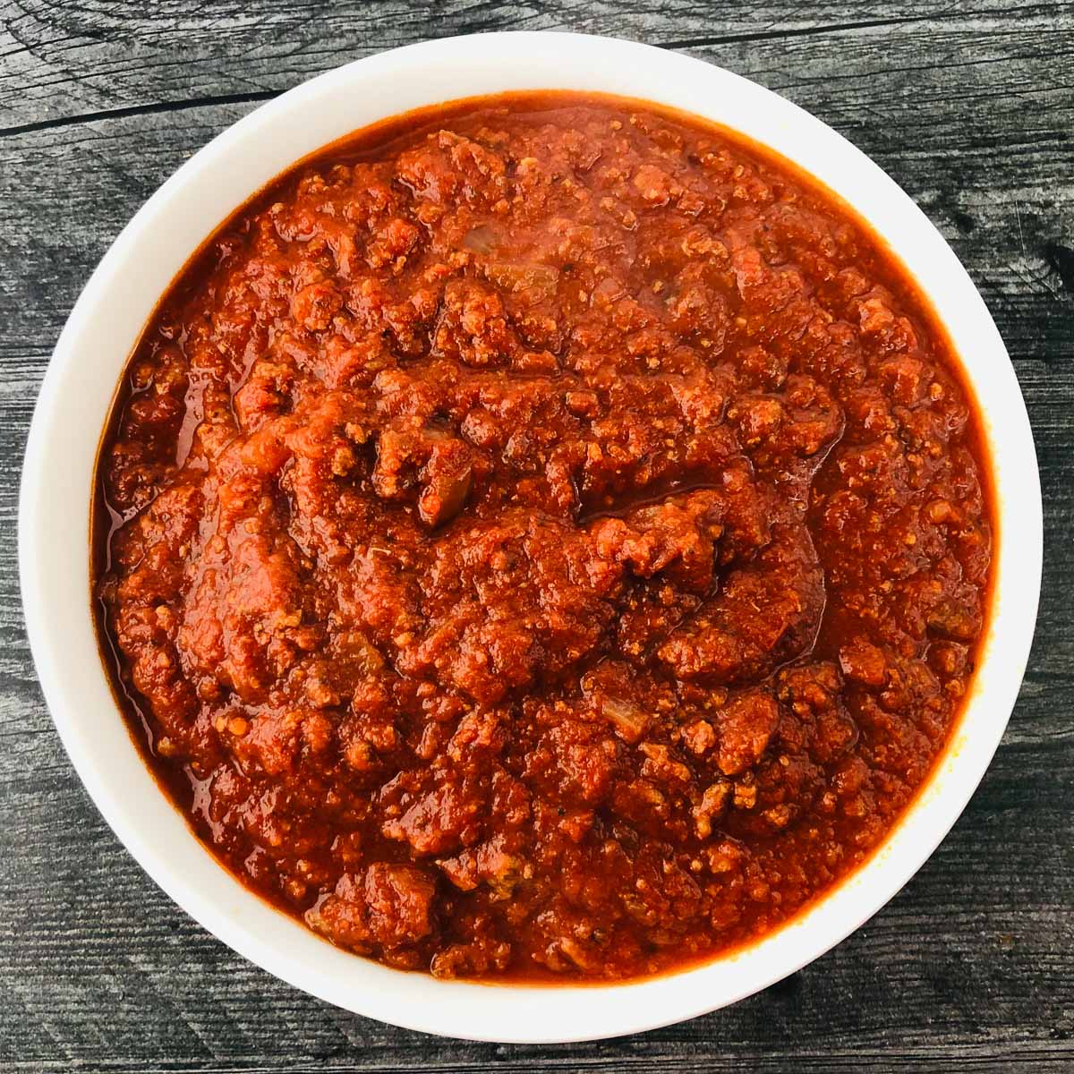 white bowl with spaghetti sauce with meat made in the slow cooker