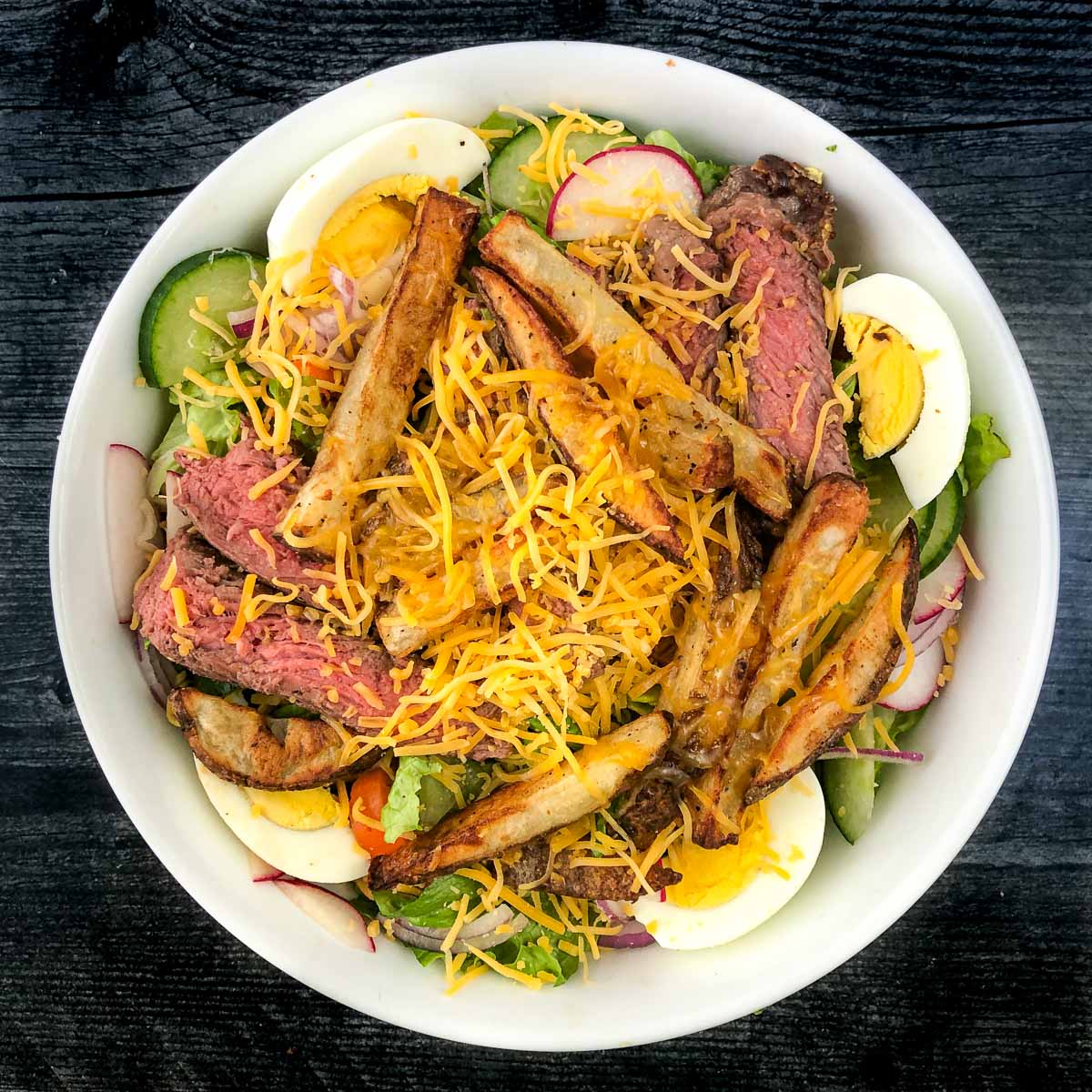 white bowl with air fryer steak salad