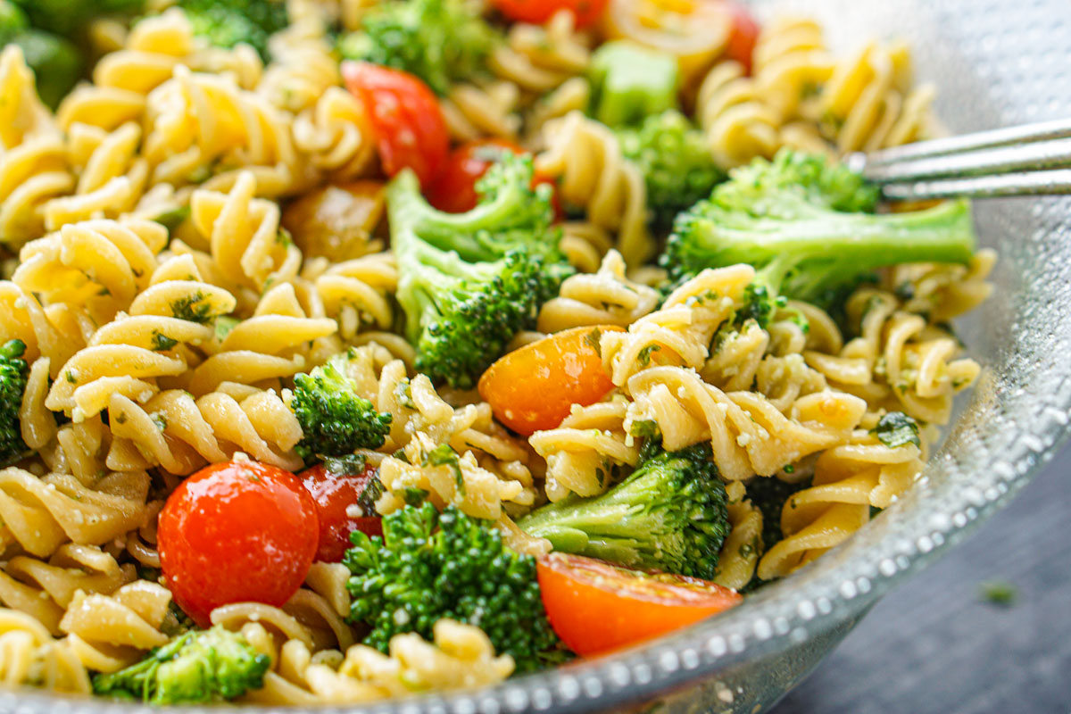 closeup of glass bowl with chickpea pasta and broccoli salad