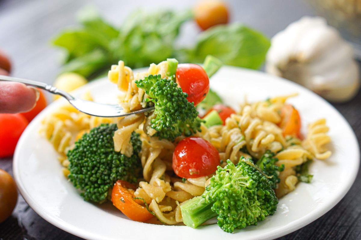 forkful of pasta salad with pesto broccoli