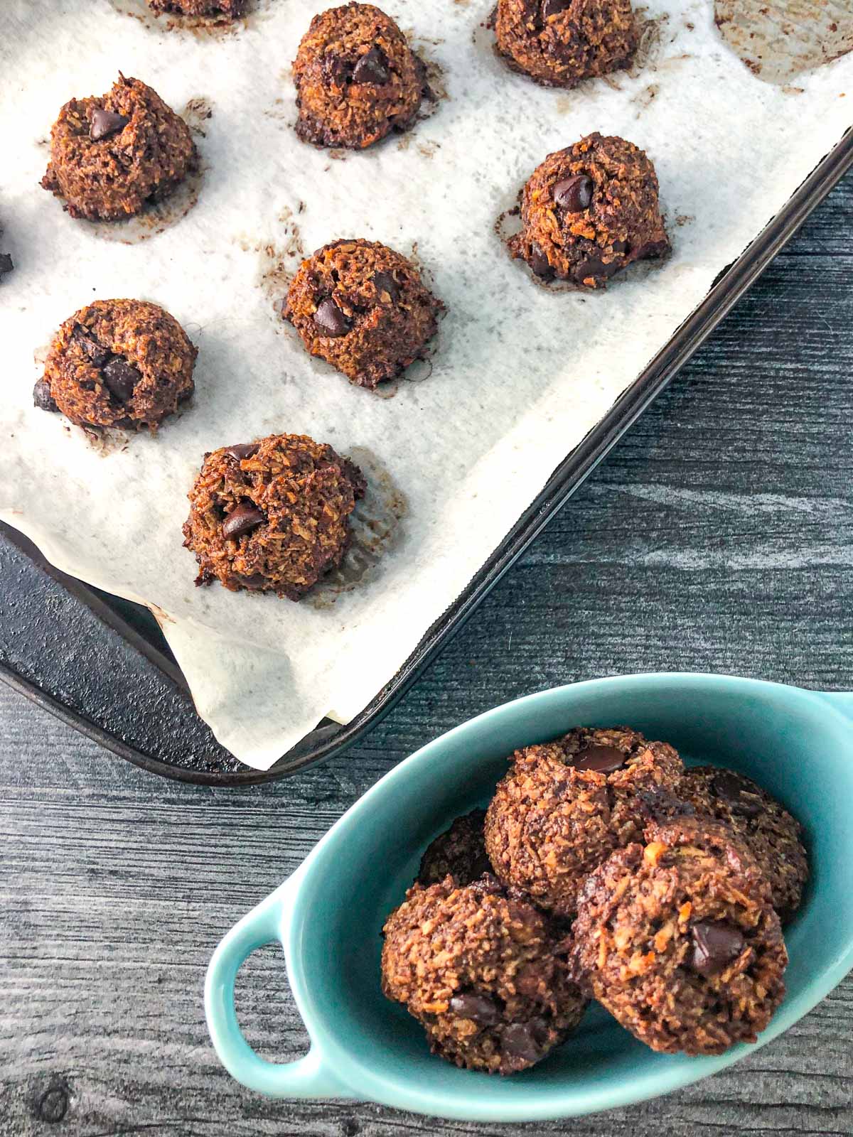 aerial view of a cookie sheet with keto cookies and blue bowl filled with them