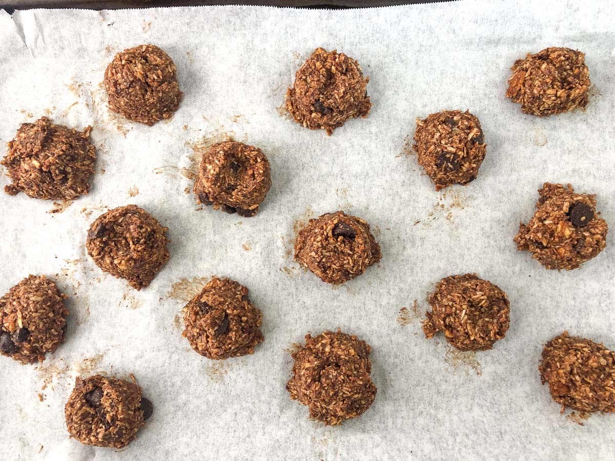 raw cookies on a parchment covered baking sheet 