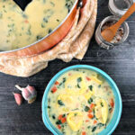 orange pot and aqua bowl with healthy tortellini soup using cauliflower cream with text