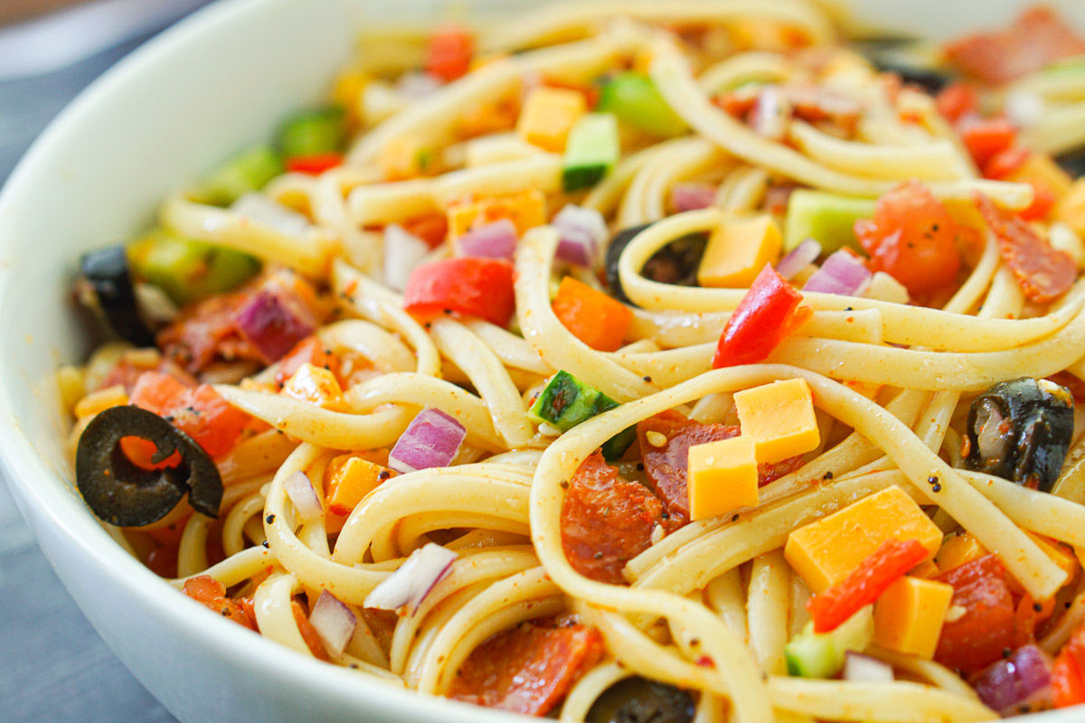 closeup of white bowl with the cheese and pepperoni linguine salad