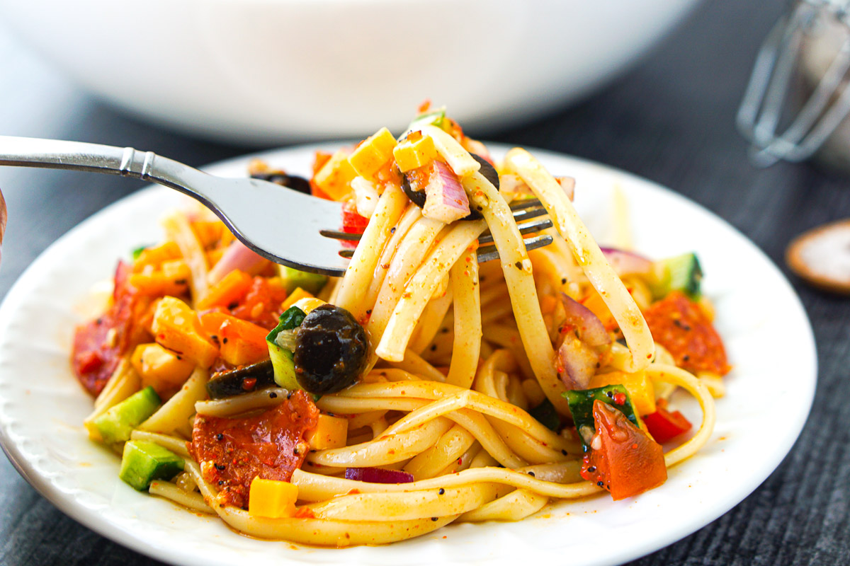 a forkful of linguine salad using salad supreme