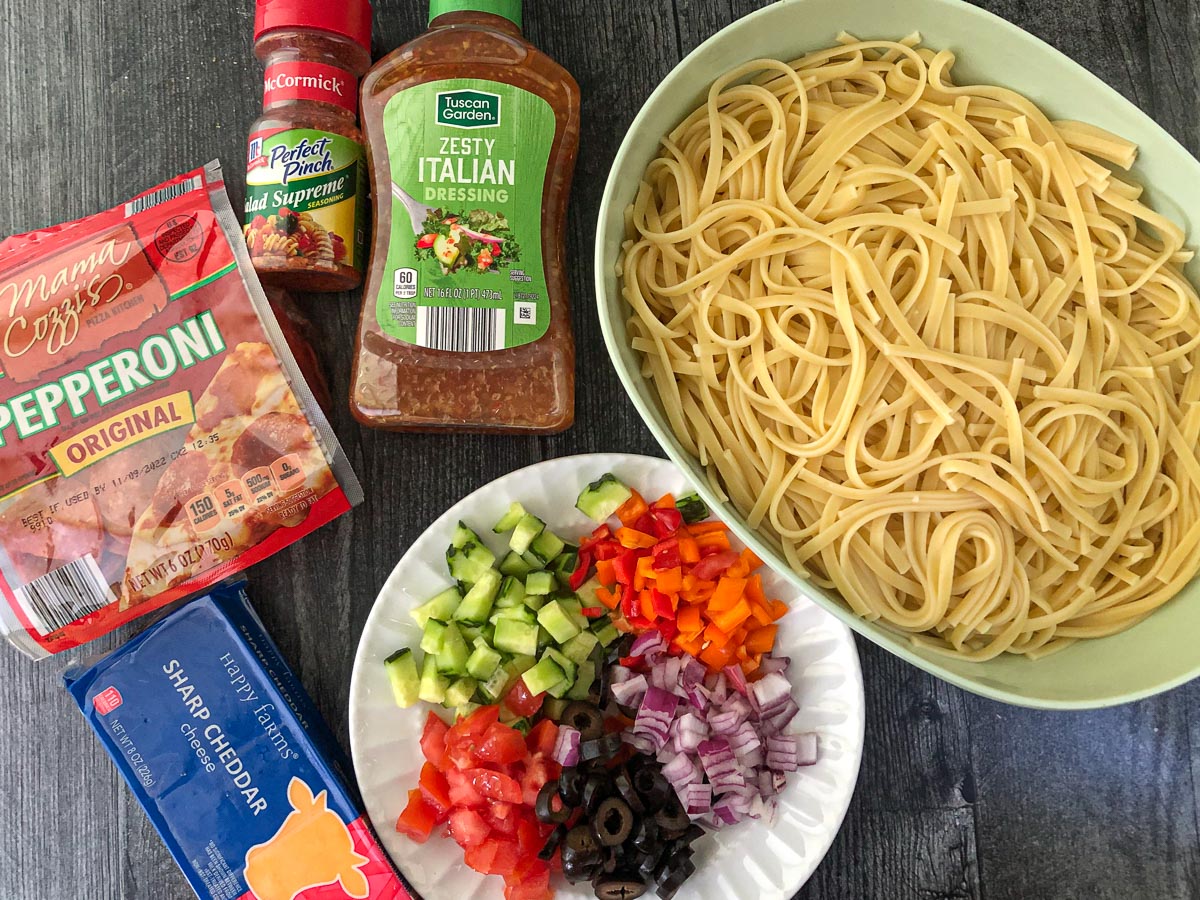 recipe ingredients - cooked pasta, pepperoni, cheddar cheese, Italian dressing, seasoning, chopped veggies