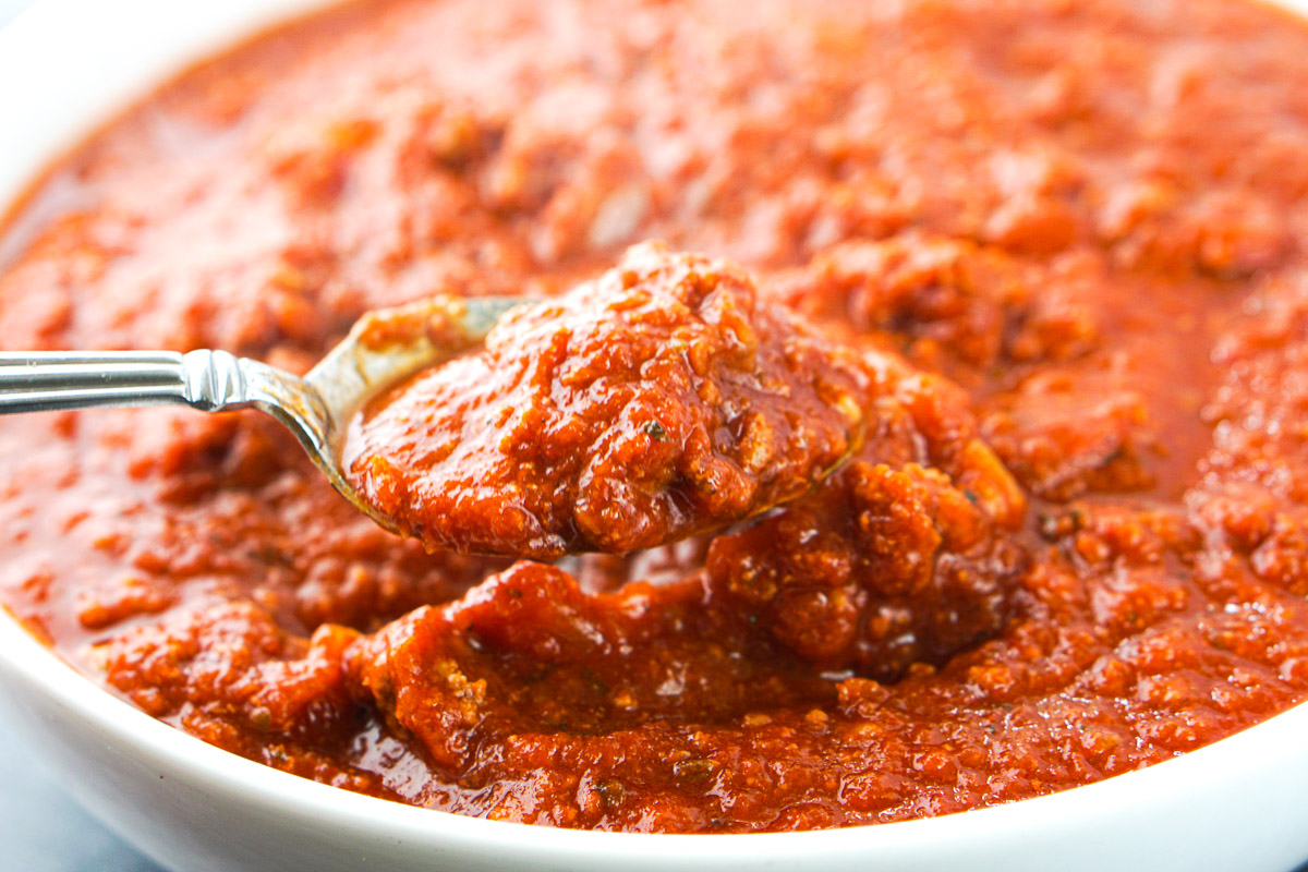 closeup of a spoonful of spaghetti sauce with meat