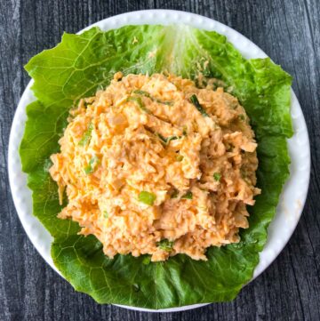 aerial view white plate with keto buffalo chicken salad on a piece of lettuce