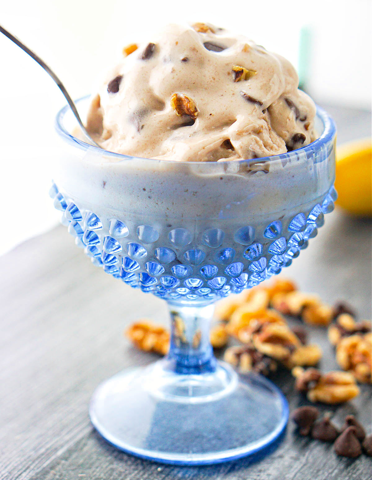 blue glass dessert dish with healthy ice cream and a spoon