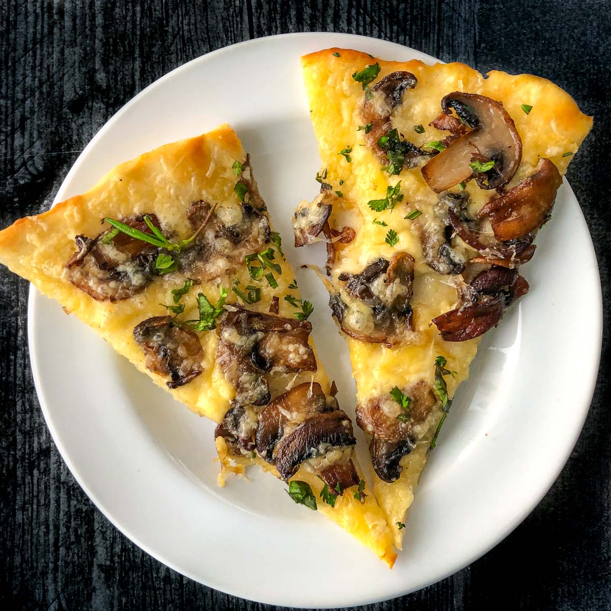 white plate with 2 pieces of mushroom flatbread using 2 ingredient dough