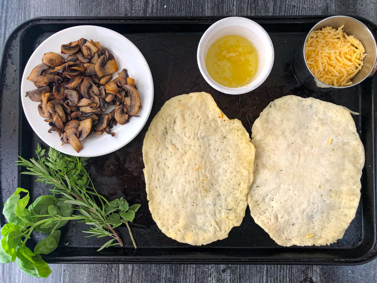 cookie sheet with plain flatbreads and fixings