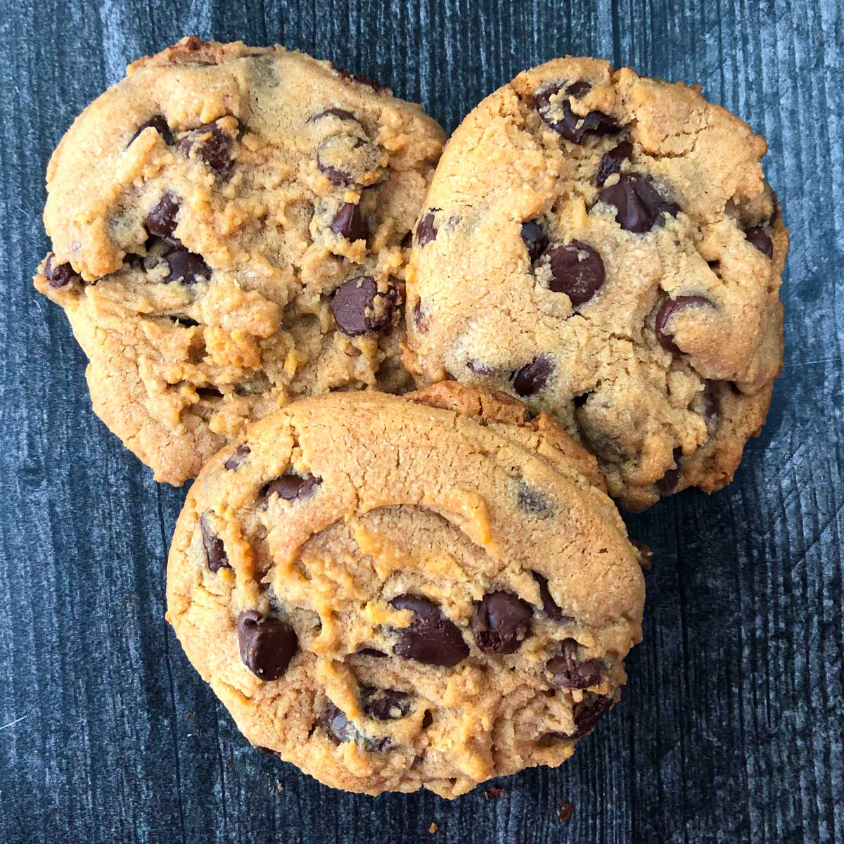 3 peanut butter chocolate chip cookies on a table