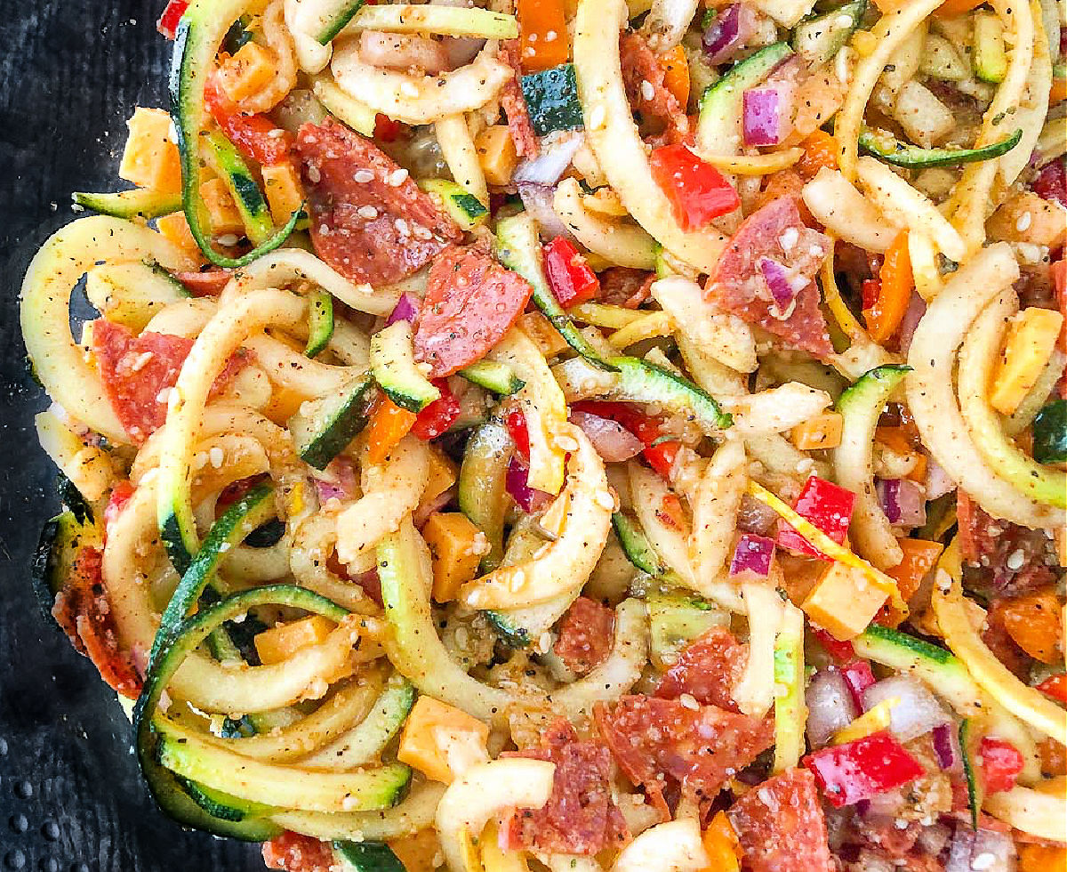 closeup of a bowl of low carb linguine salad using zoodles