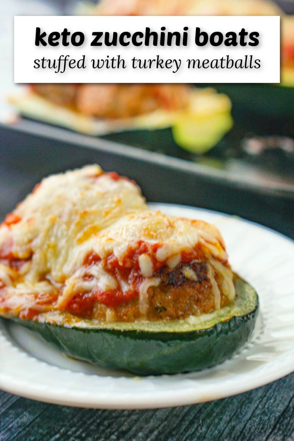 closeup of keto zucchini boats stuffed with meatballs, sauce and cheese and text