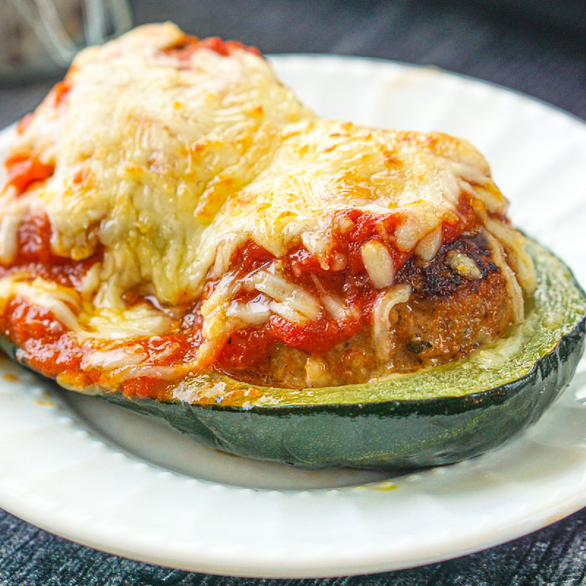 a piece of meatball sub on white plate