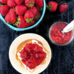 aerial view of fresh strawberries and toast with strawberry jam with text