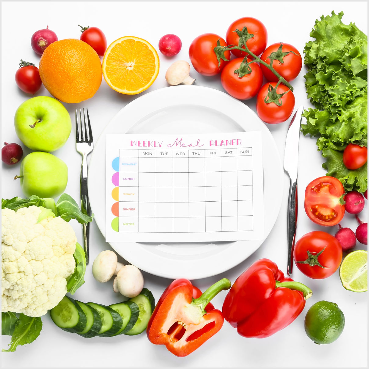meal planner with fresh veggies and fruit around