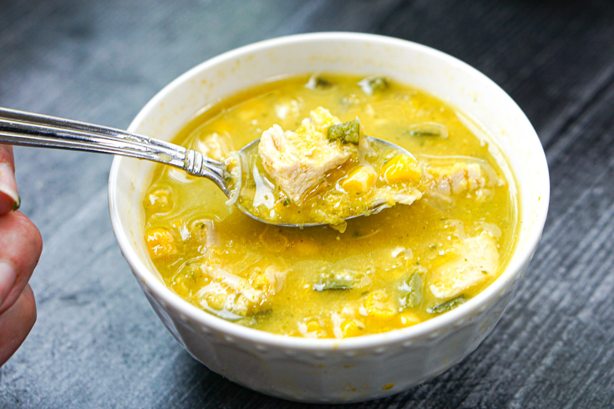 closeup of a spoonful of poblano corn and chicken soup