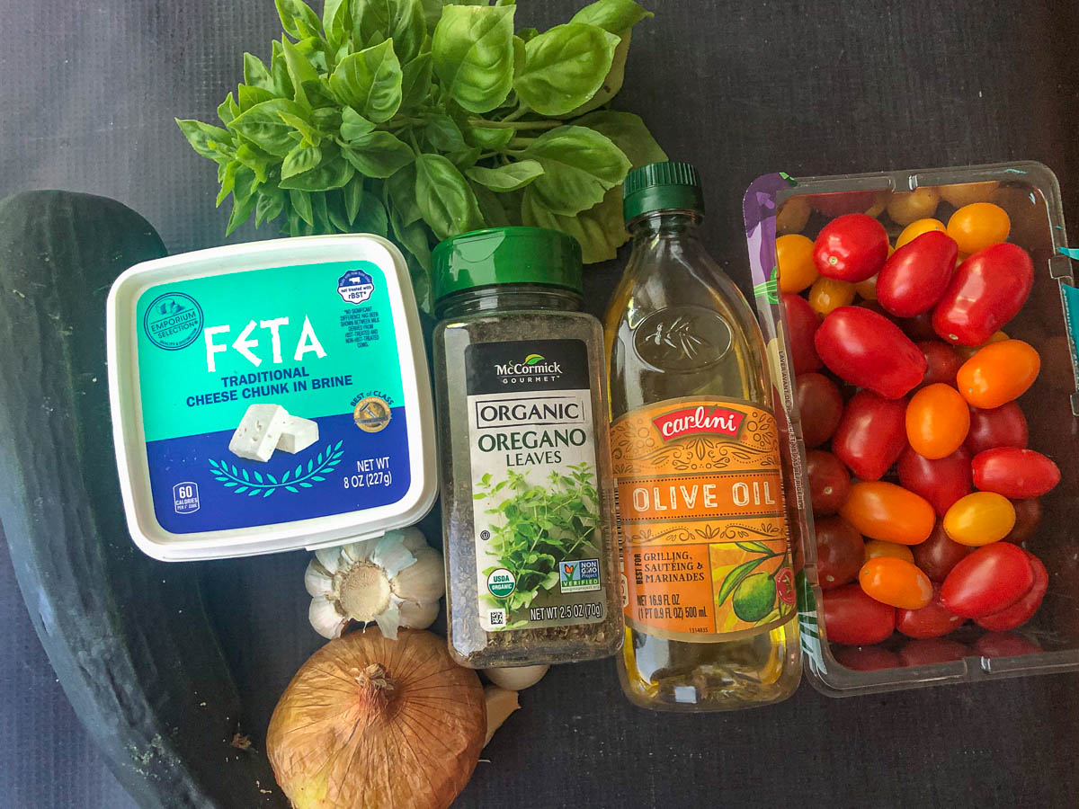 recipe ingredients - zucchini, feta, onion, garlic, olive oil, basil, tomatoes, oregano