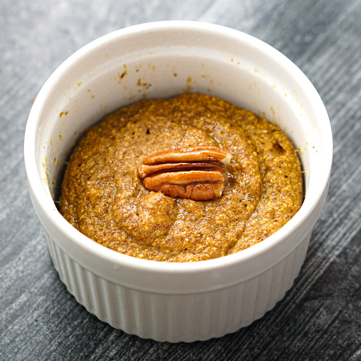 white ramekin with healthy baked pumpkin spice oatmeal