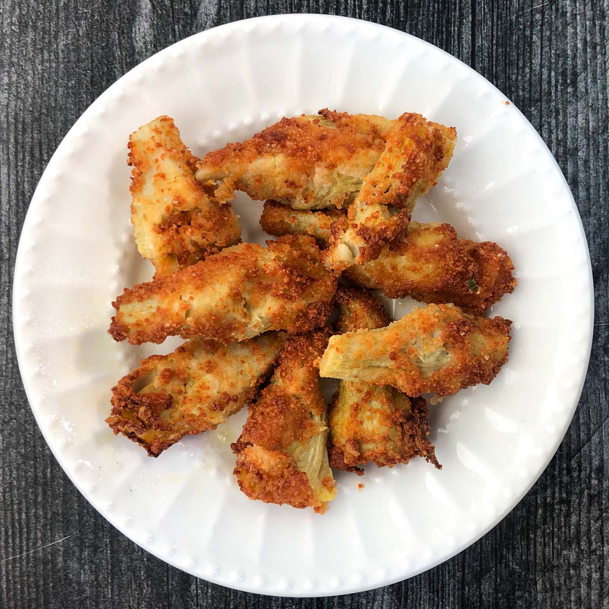 keto air fryer artichoke hearts on a white plate