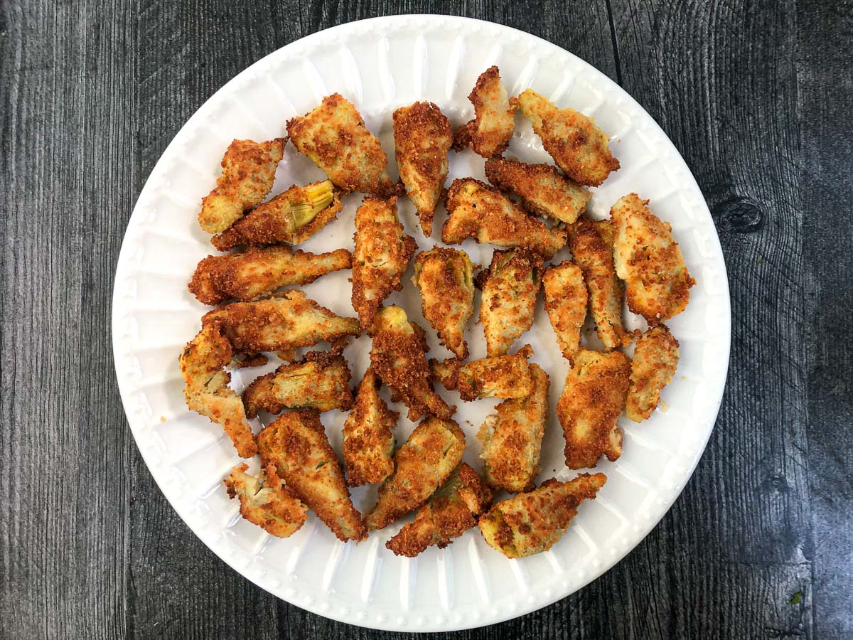 white plate with keto fried artichokes