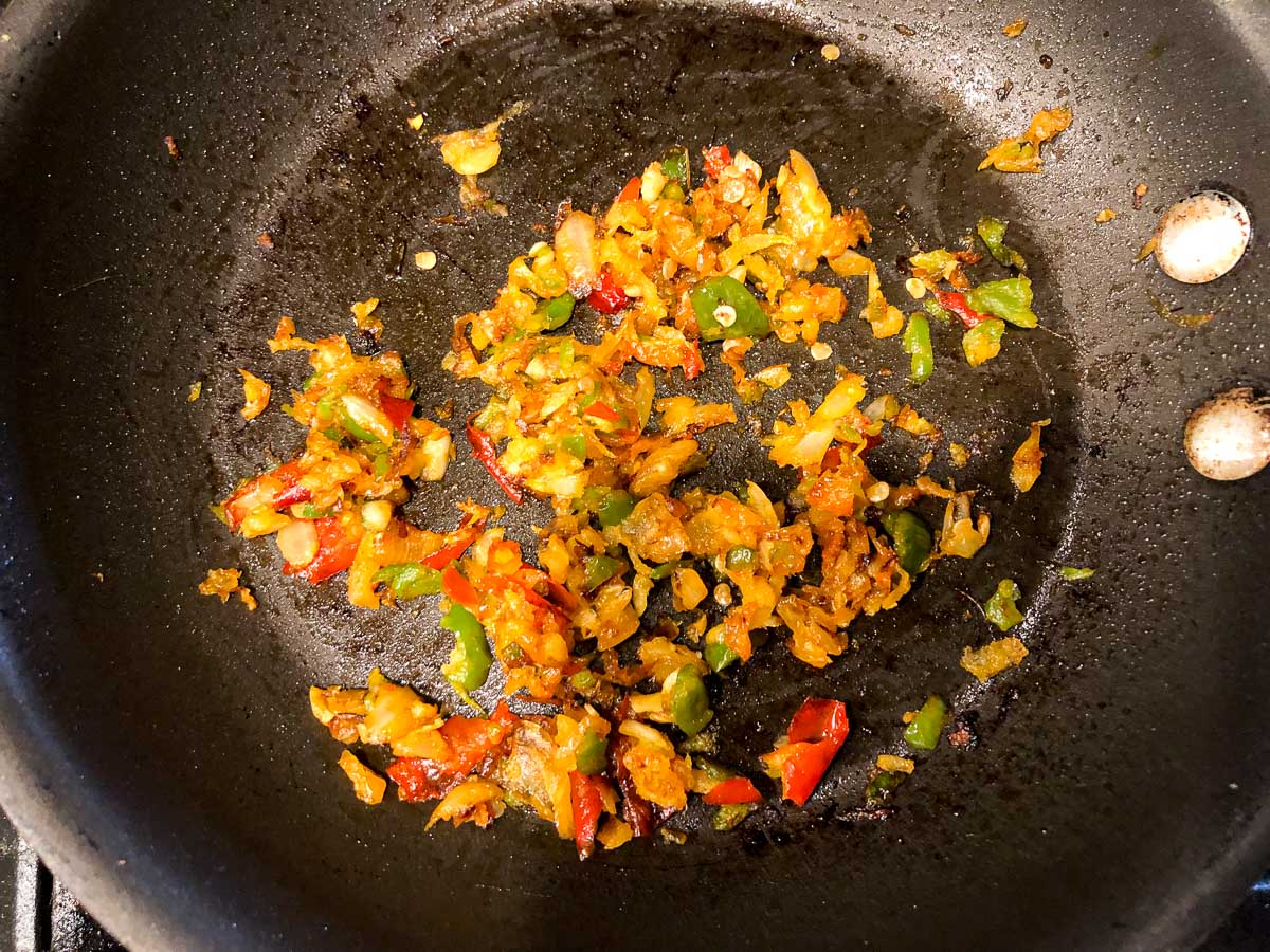 skillet with sautéed peppers, onions and garlic