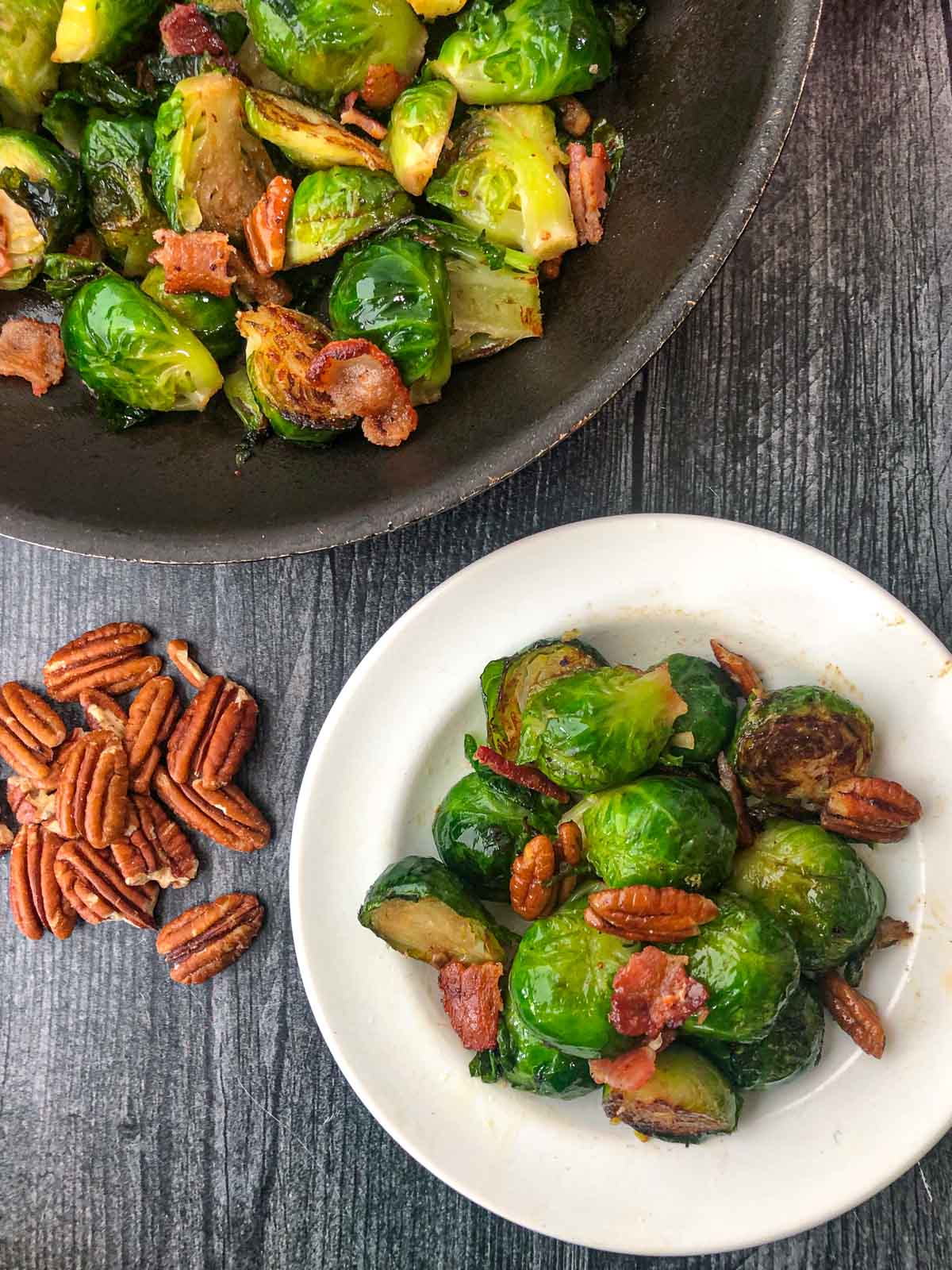 aerial view of a pan and plate with roasted Brussels sprouts with pecans and bacon