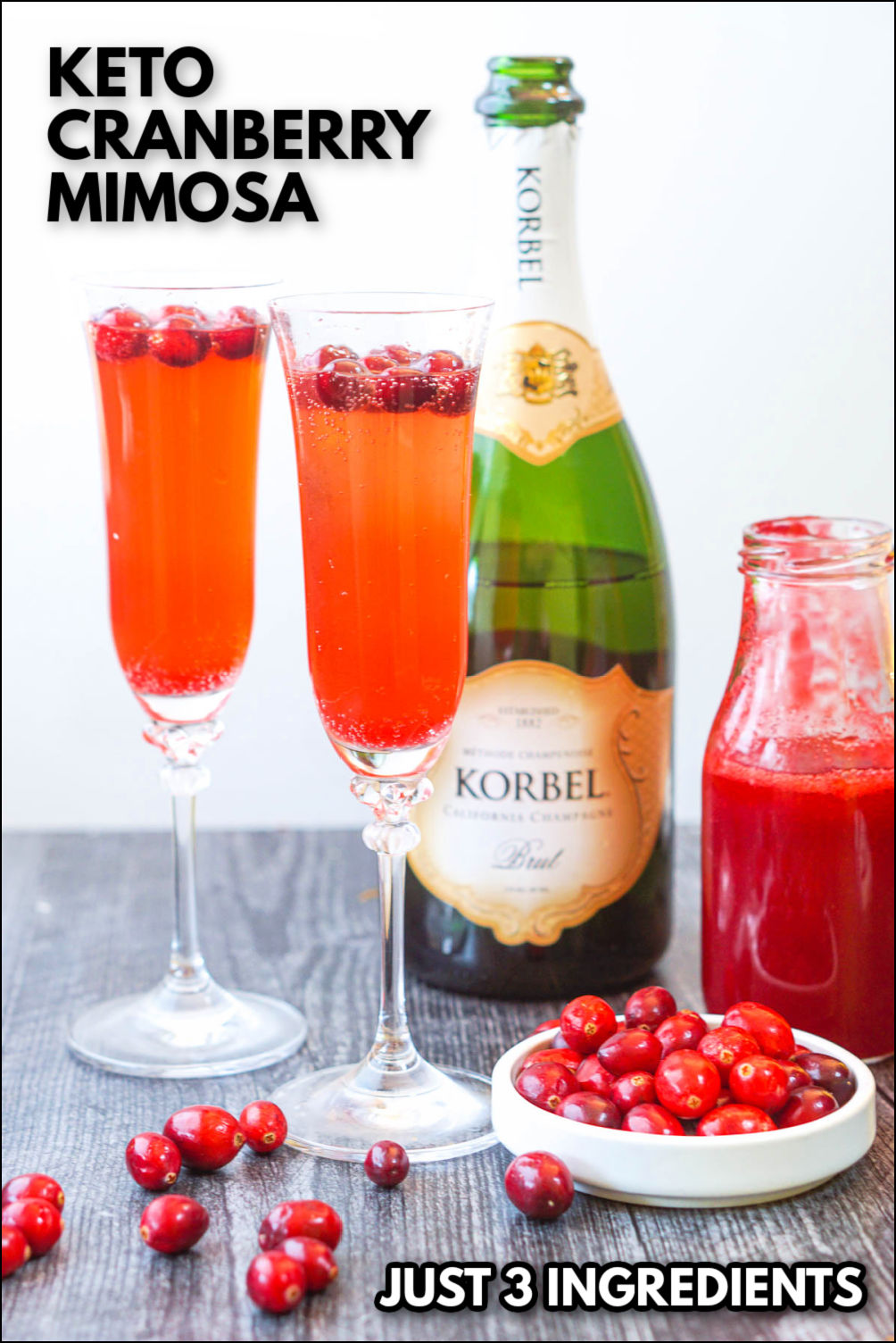 2 champagne flutes with the keto cranberry mimosas and text