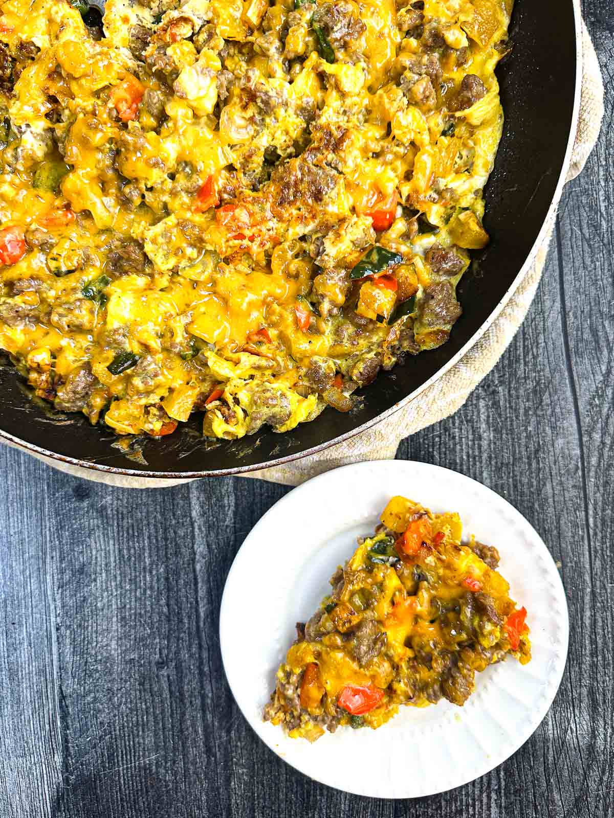 Aerial view of a skillet and plate with a keto breakfast casserole.