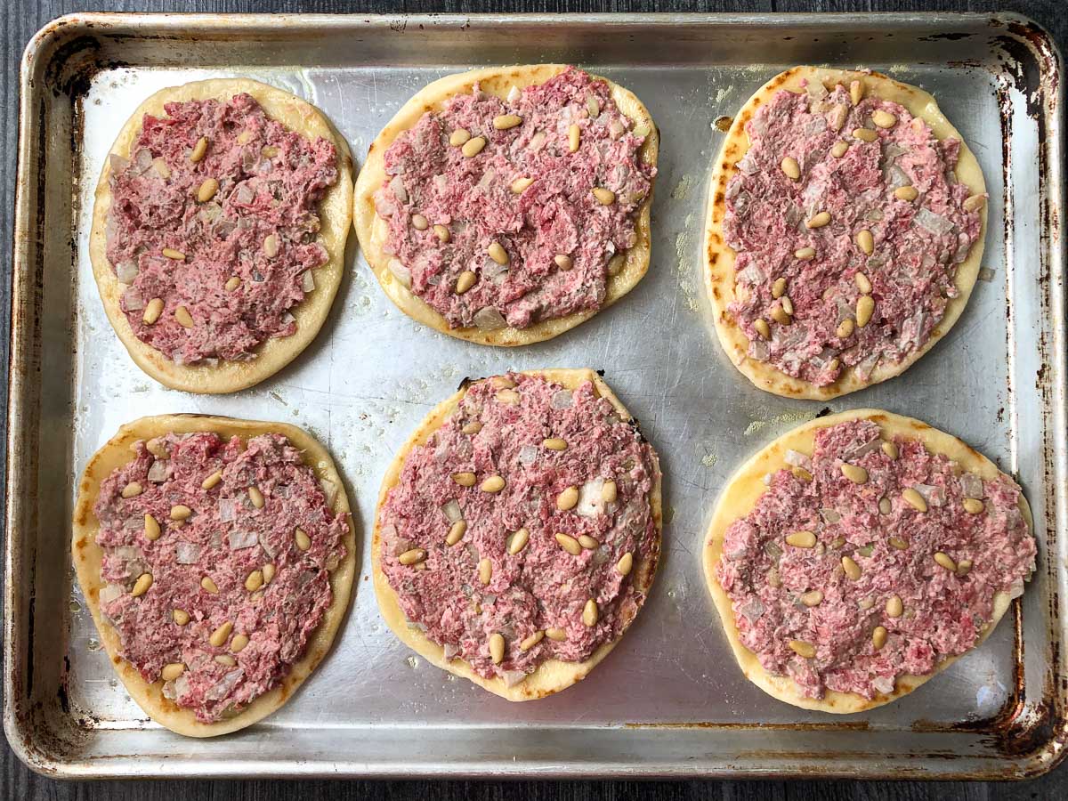 baking sheet with meat pies ready to go in the oven