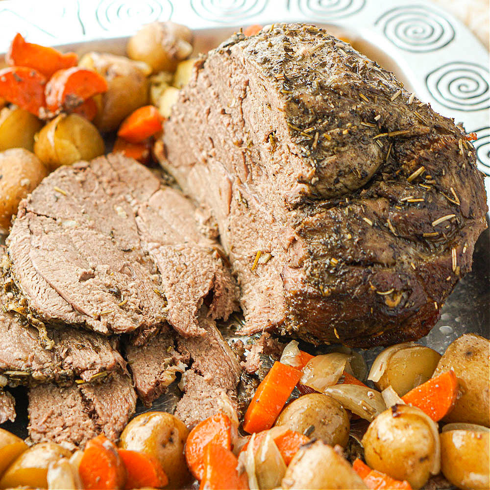 closeup of a slow cooker lamb roast with veggies