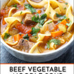 white bowl with vegetable beef noodle soup with fresh parsley and text