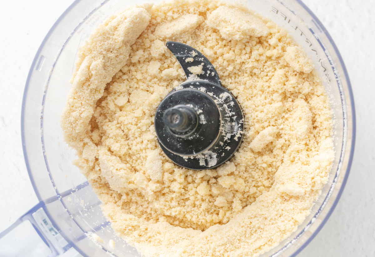 food processor with flour ingredients and  butter mixed