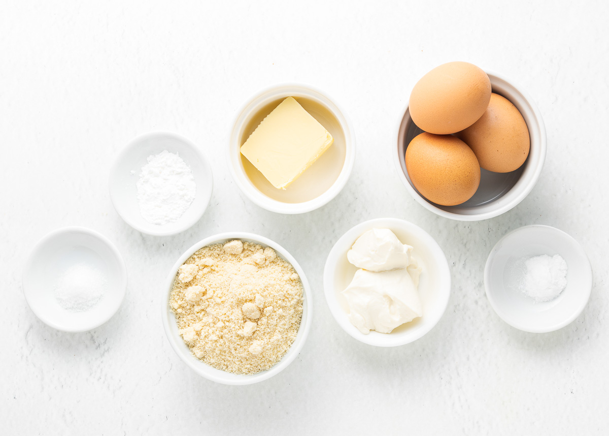 keto biscuit ingredients - eggs, almond and coconut flour, butter, salt, baking powder, baking soda and cream cheese