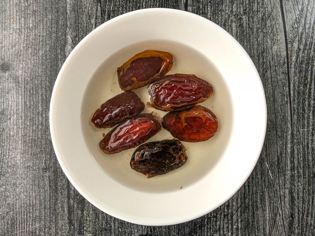 white bowl with dates soaking in water