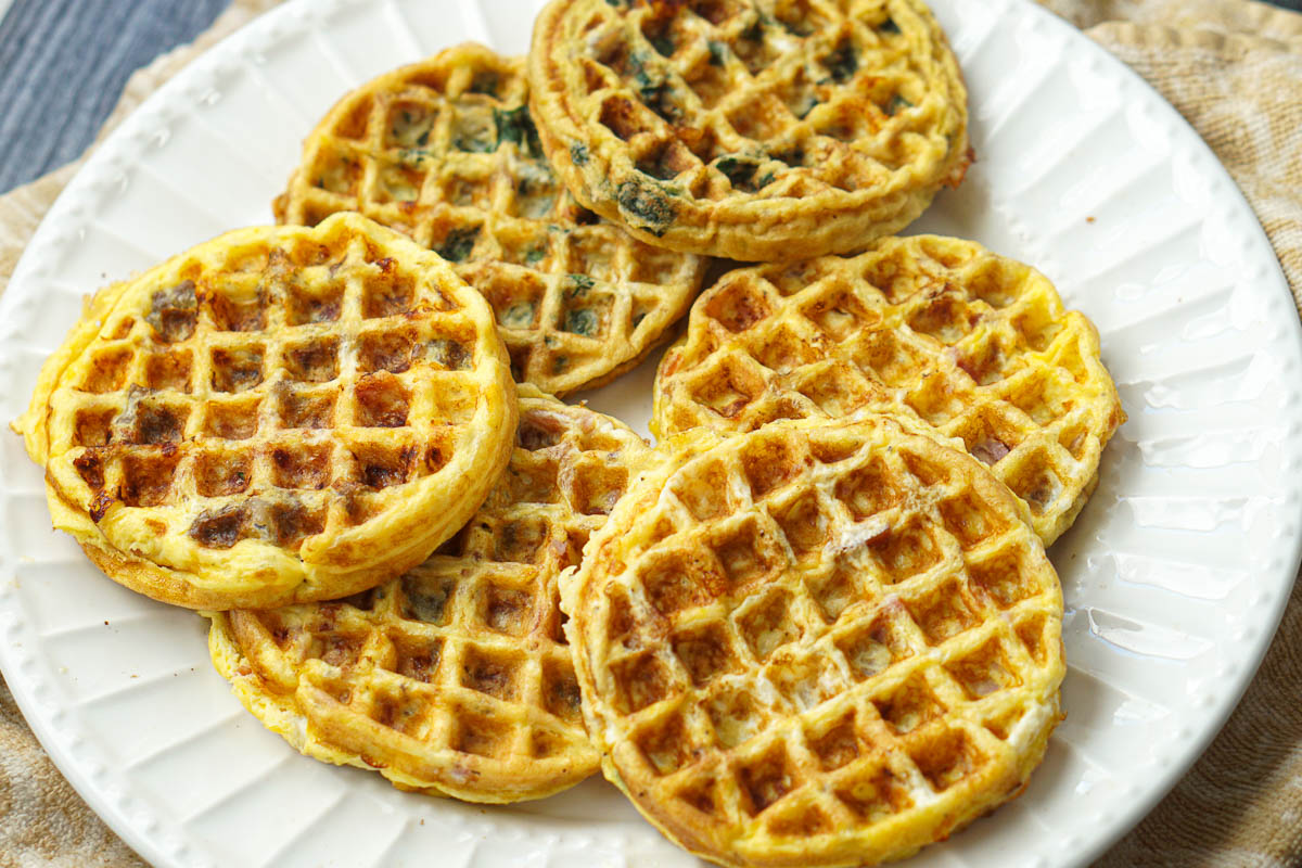 white plate with a mixture of different flavored low carb omelet waffles